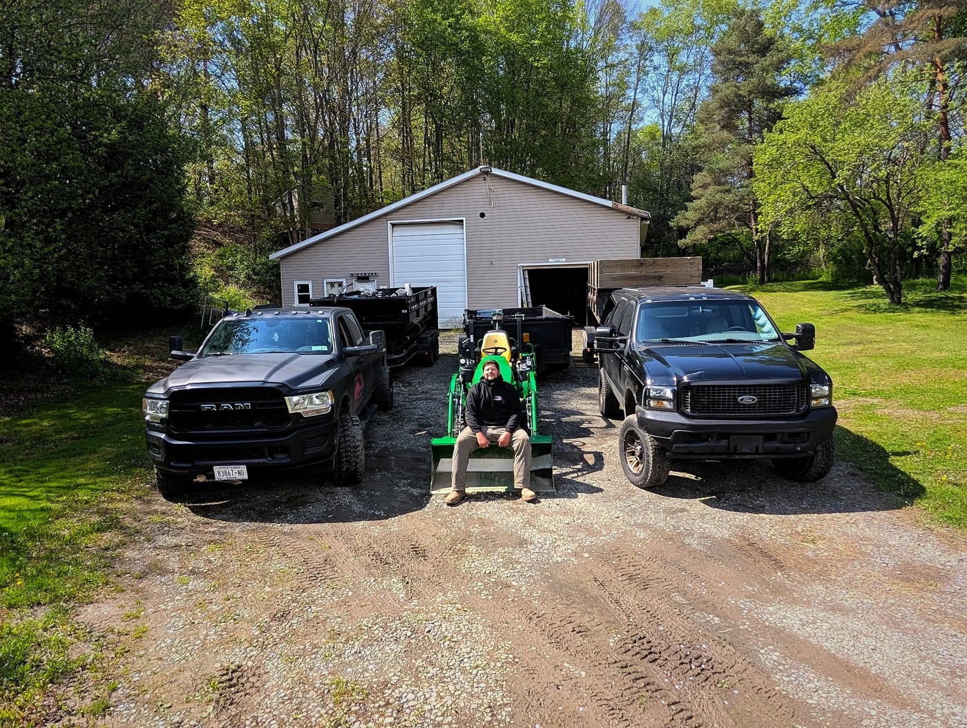 Clear It Out trucks and roll-off equipment in a yard