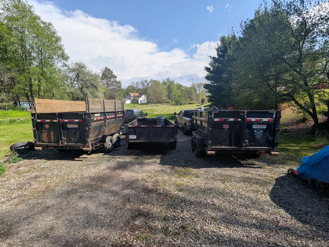 Roll-off trailers lined up on a gravel drive